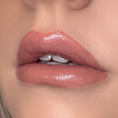 Close-up of a person's lips with a glossy lip color