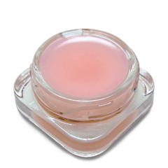 Pink lip balm in a clear container on a white background