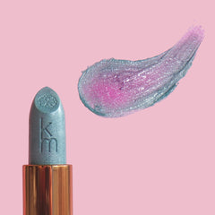 Lipstick with glittery pink and blue shade on a pink background