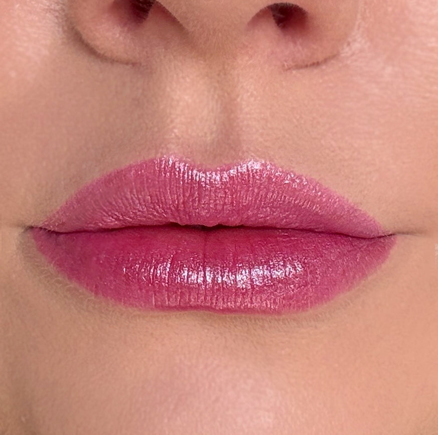 Close-up of a person's lips with pink lipstick