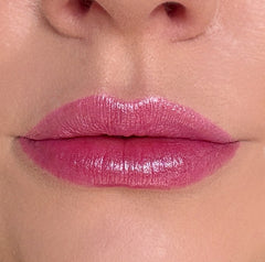Close-up of a person's lips with pink lipstick
